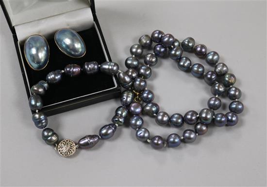 A single strand Tahitian? cultured pearl necklace, a similar bracelet and a pair of 9ct gold mounted earclips.